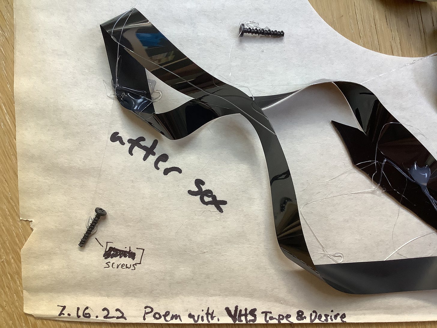 A couple screws, labeled “[screws],” the text “after sex” and “7.16.22 Poem with VHS Tape and Desire,” and an adornment of magnetic tape and glue