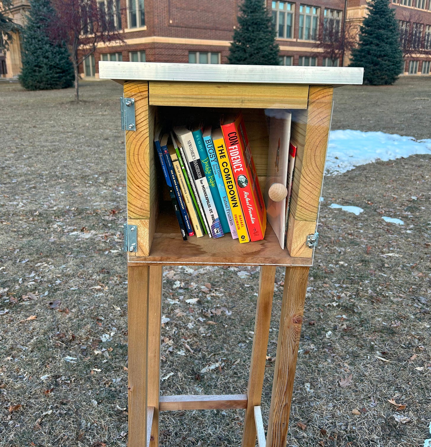 Confidence, Bugsy, and The Comedown in a little library with a plexiglass window