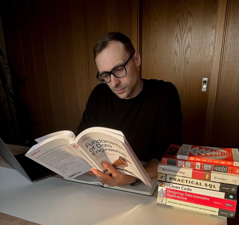 Manuel Djirlic studying books about data engineering.