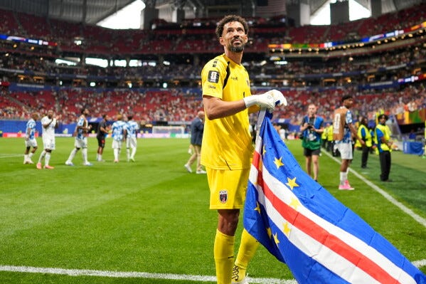 Cape Verde goalkeeper Vozinha celebrates as holds the flag of his country after the World Cup Group H soccer match between Spain and Cape Verde in Atlanta, Monday, June 15, 2026. (AP Photo/Mike Stewart)