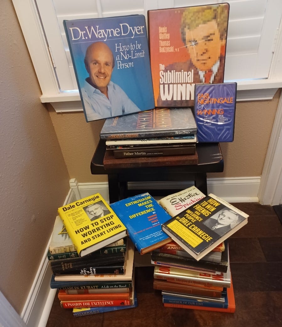 Multiple stacks of Dad's self-improvement books.