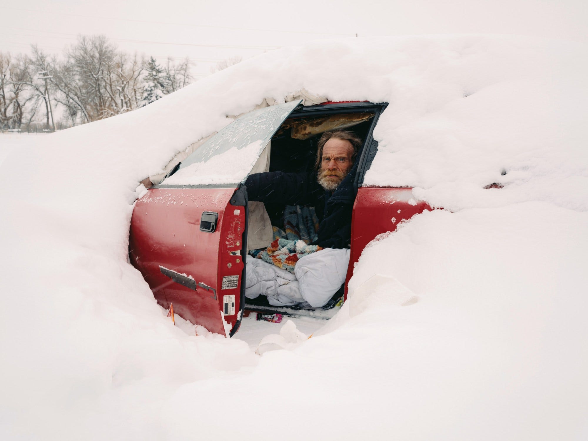 Joshua Powell, 41, lives in his car even during sub-zero weather. Here, he uses his car door to clear away snow so he can climb into and out of the vehicle. Joshua Powell, 41, lives in his car even during sub-zero weather. Here, he uses his car door to clear away snow so he can climb into and out of the vehicle.