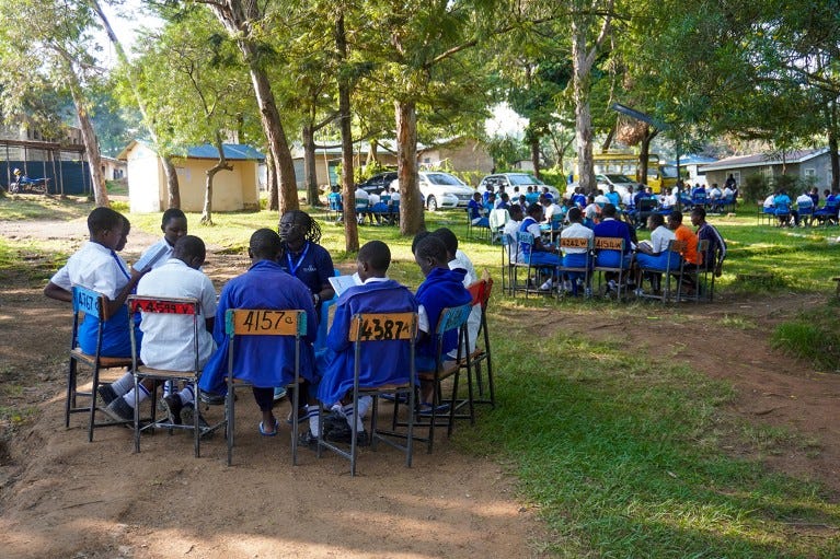 Several groups of students and mentors at a Shamiri Event Group Discussion at a girls school in Kisumu, Kenya. Several groups of students and mentors at a Shamiri Event Group Discussion at a girls school in Kisumu, Kenya.