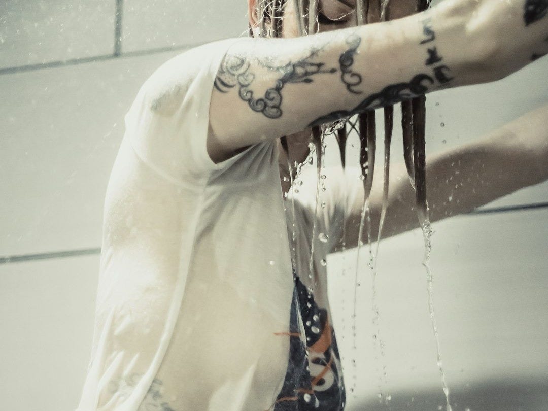 woman in white T-shirt while shower in bathroom
