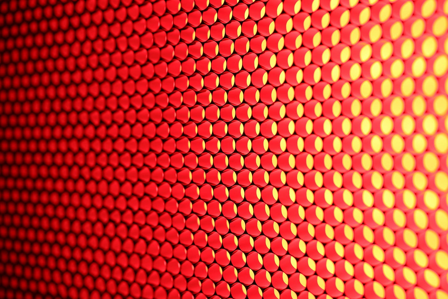A hexagonal array of many red and yellow circular light sources