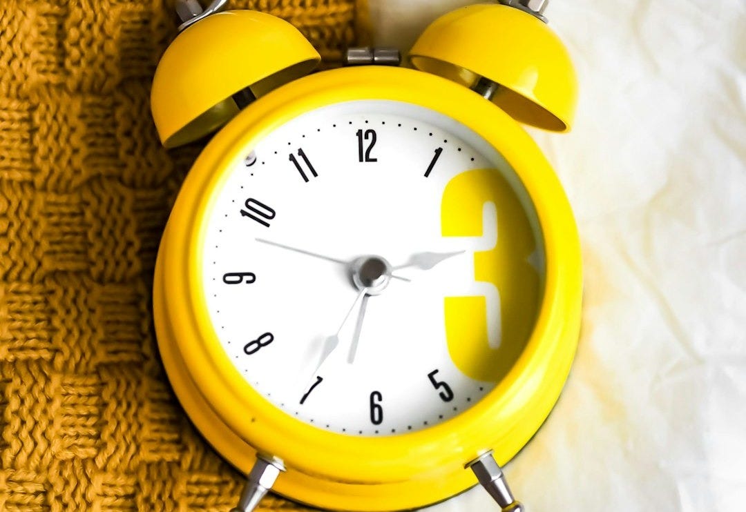 yellow and white alarm clock at 10 10
