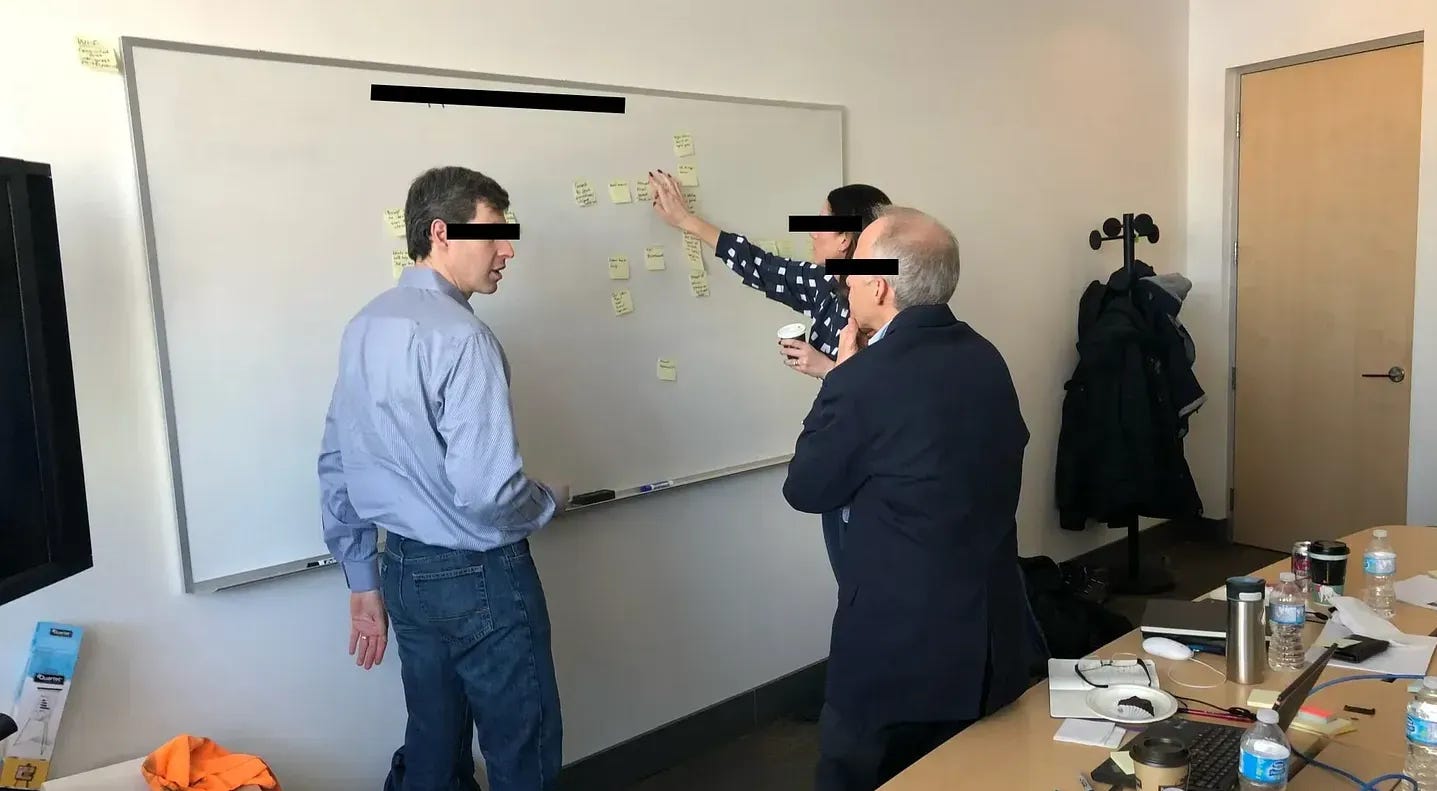 A team arguing at the whiteboard A team arguing at the whiteboard