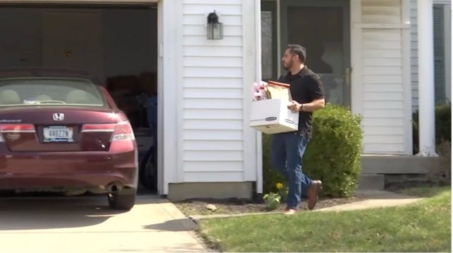 A person carrying a box

AI-generated content may be incorrect.