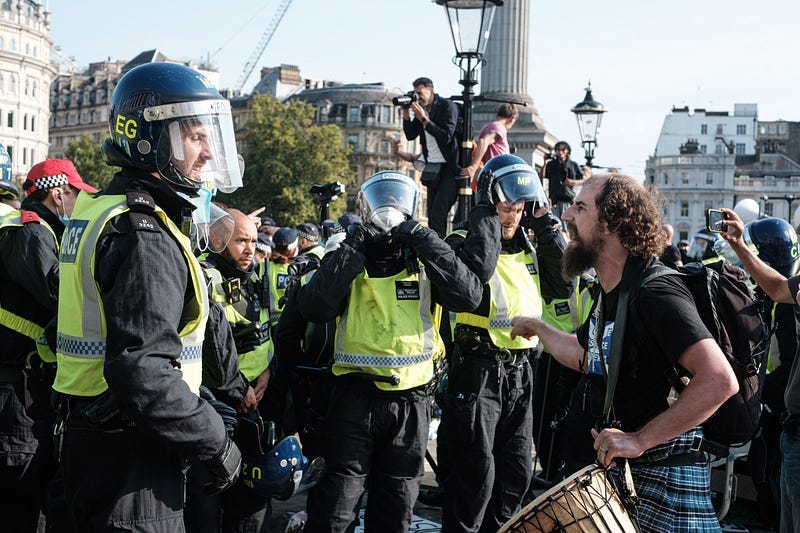 Protestor arguing with cops in tactical gear