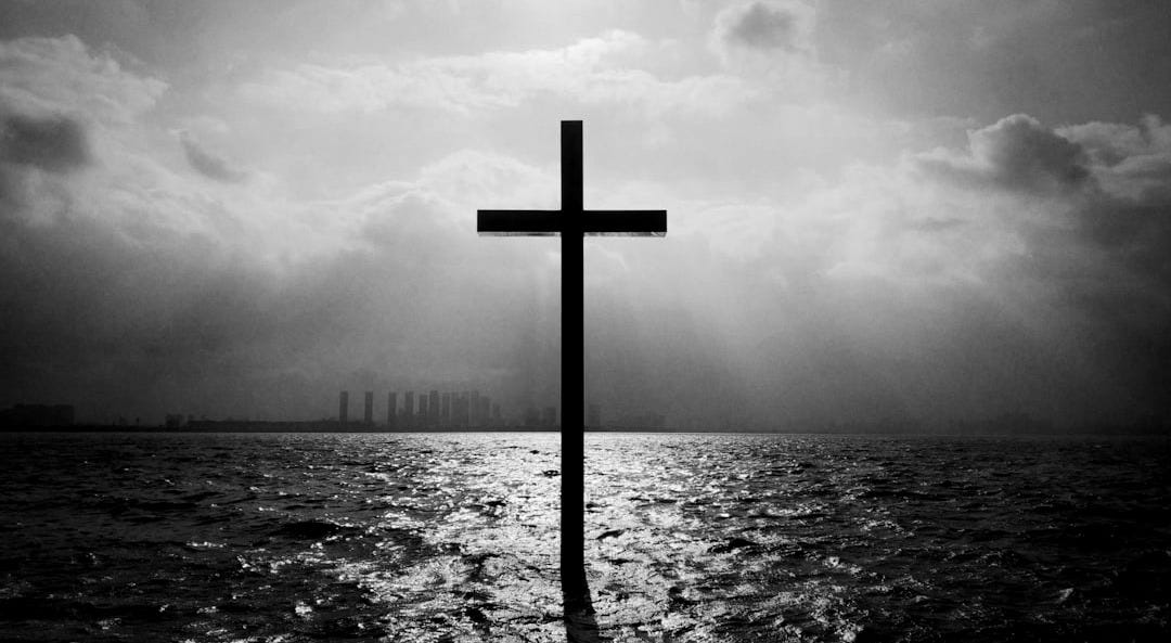 brown wooden cross on beach during daytime brown wooden cross on beach during daytime