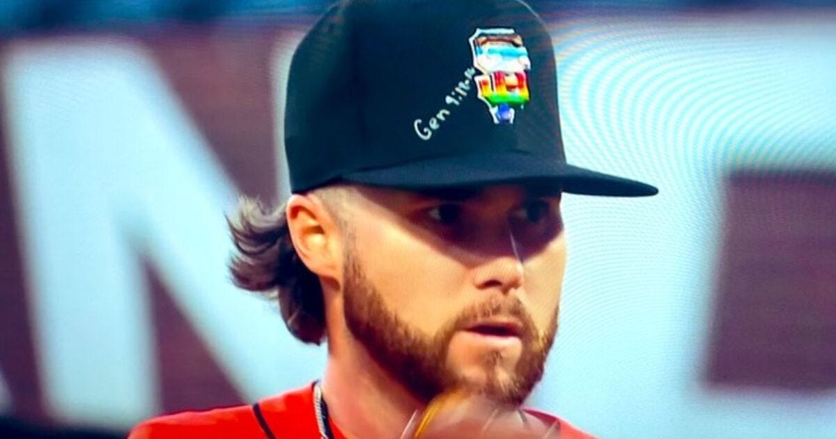 Close-up of a baseball player wearing a black cap with a colorful design, focused on the game during a match.