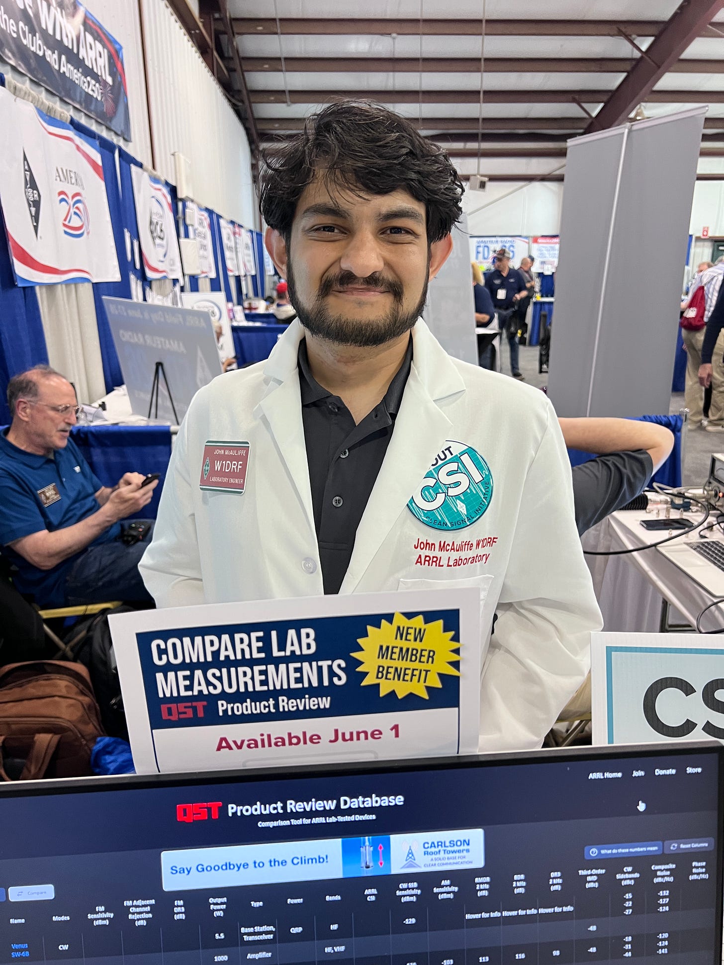 John McAuliffe W1DRF at Hamvention 2026, demonstrating the forthcoming QST Product Review Database website. Image courtesy of Steve Stroh N8GNJ.