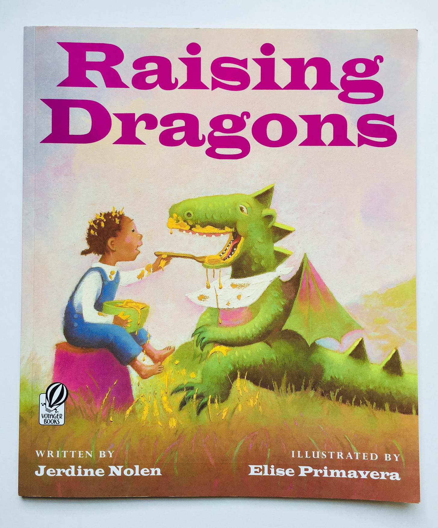 A little Black girl feeds honey to a green dragon