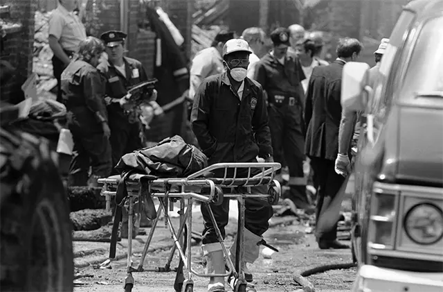 Police and emergency crews survey the charred remains of homes in West Philadelphia, day after the bombing. Police and emergency crews survey the charred remains of homes in West Philadelphia, day after the bombing.
