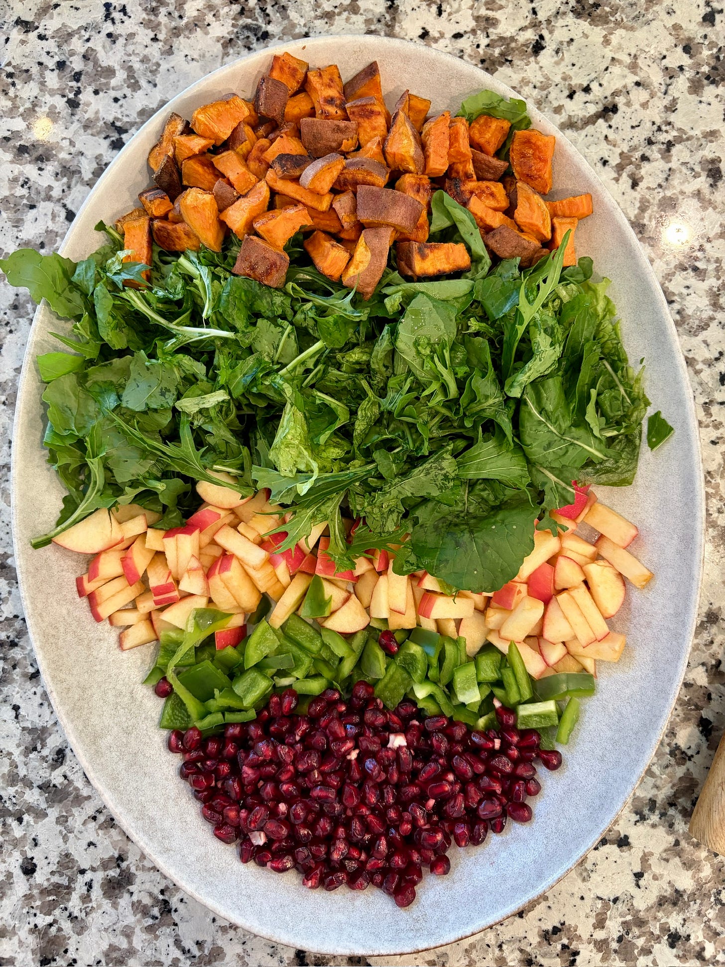 salad with roasted sweet potatoes, mixed greens, green bell pepper, red apples, and pomegranates salad with roasted sweet potatoes, mixed greens, green bell pepper, red apples, and pomegranates