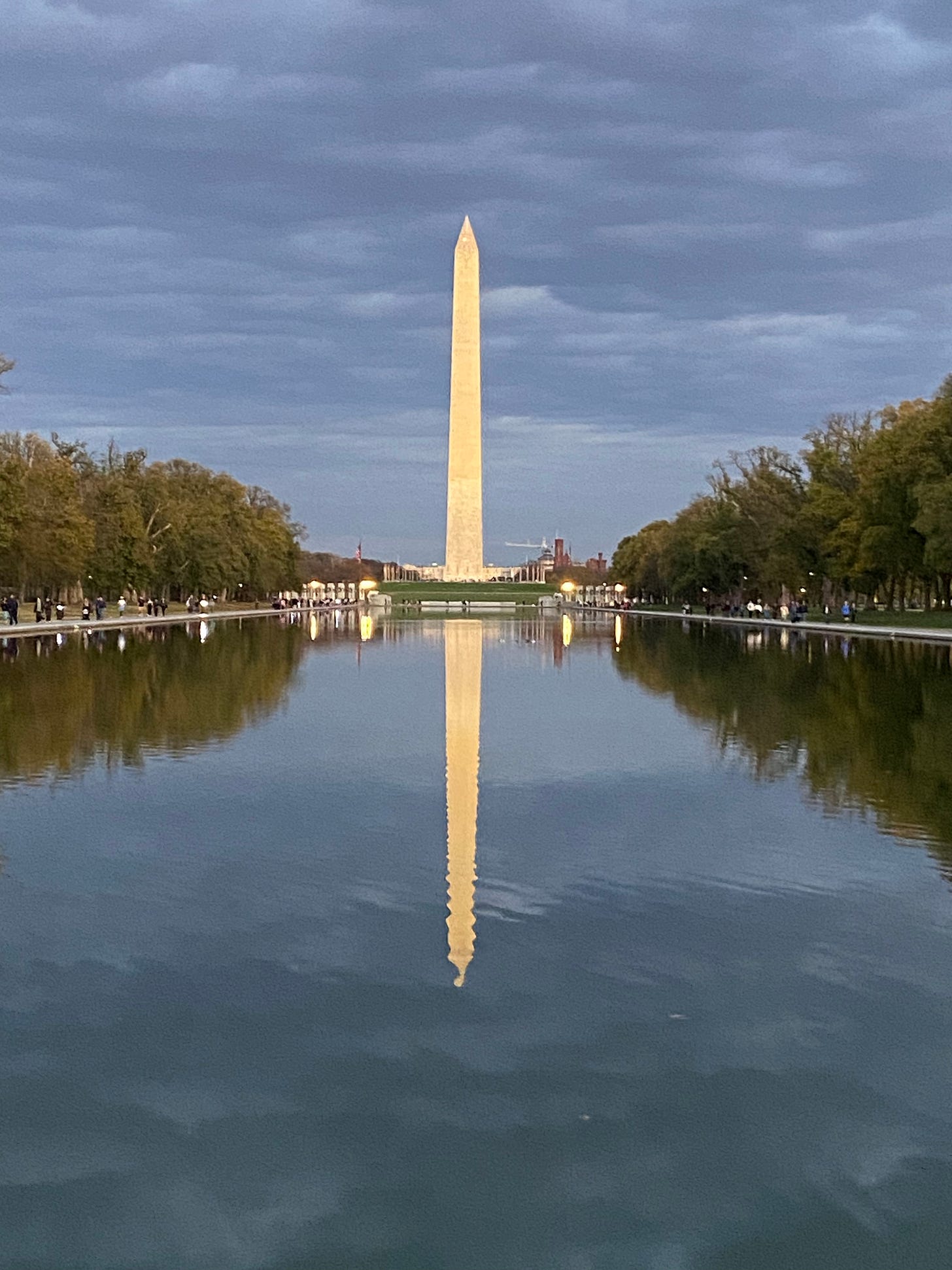 Washington Monument in sunset light reflected in water