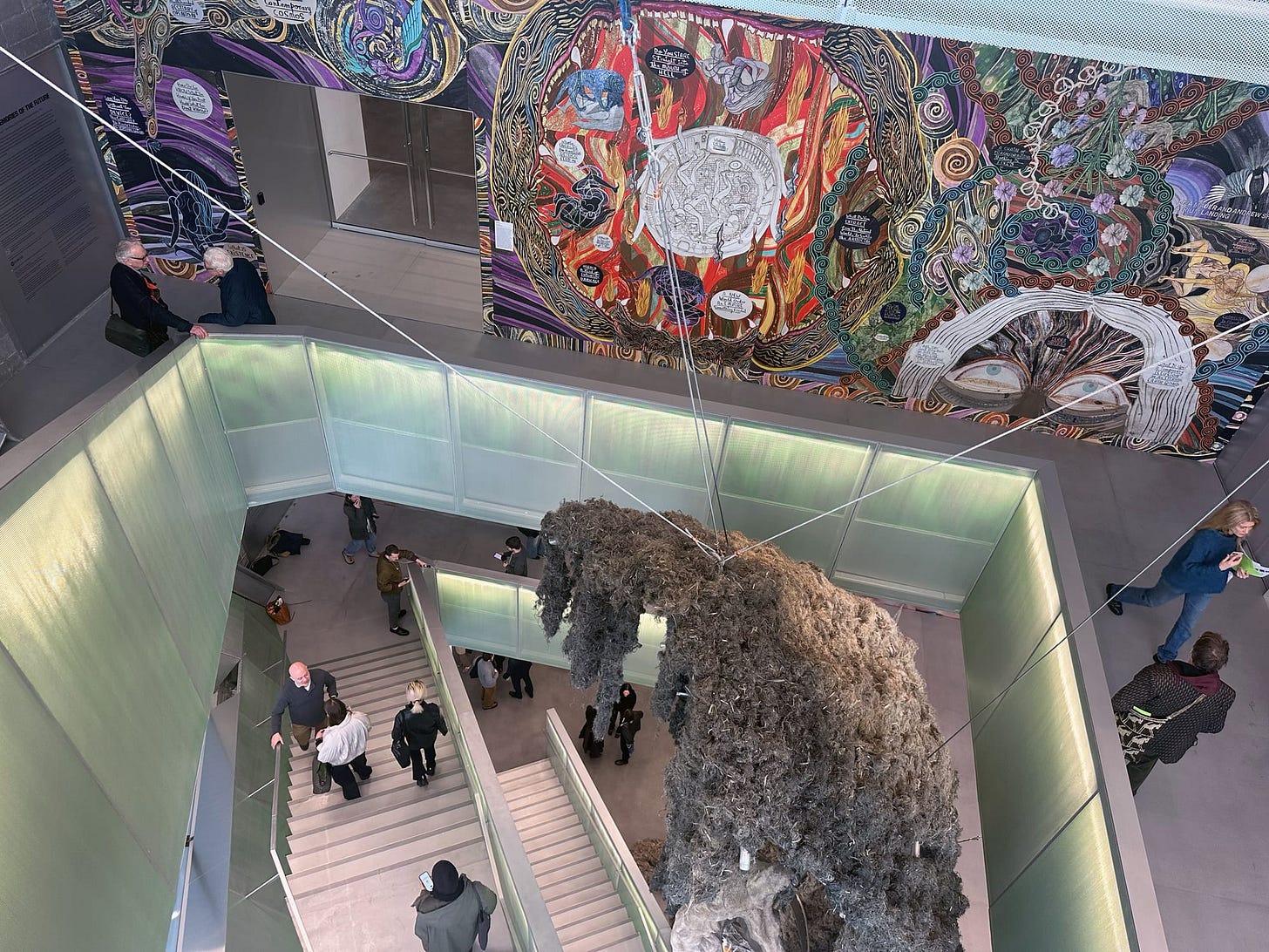 A photo from the inside of a museum with a large glass and metal staircase as the building's spine. A photo from the inside of a museum with a large glass and metal staircase as the building's spine.