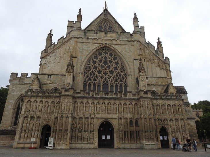 West face of Exeter cathedral with rose window, many statues and gargoyles