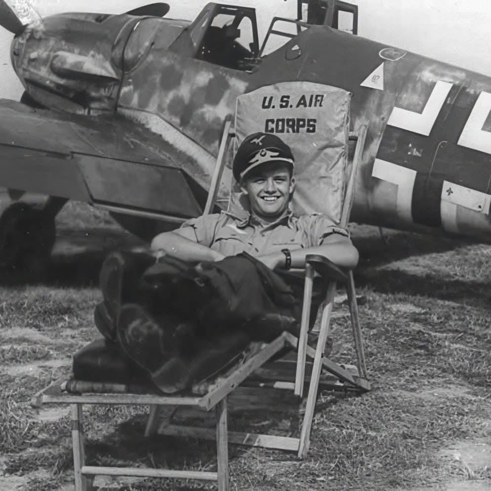 Luftwaffe ace Lieutenant Gottfried Weiroster of Stabstaffel/JG 50 relaxes in a captured American camp chair before his Bf 109 G-5/R6 'Red 3' in the Netherlands, 1943.