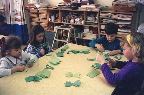 Children making paper shamrocks for St. Pat's Day