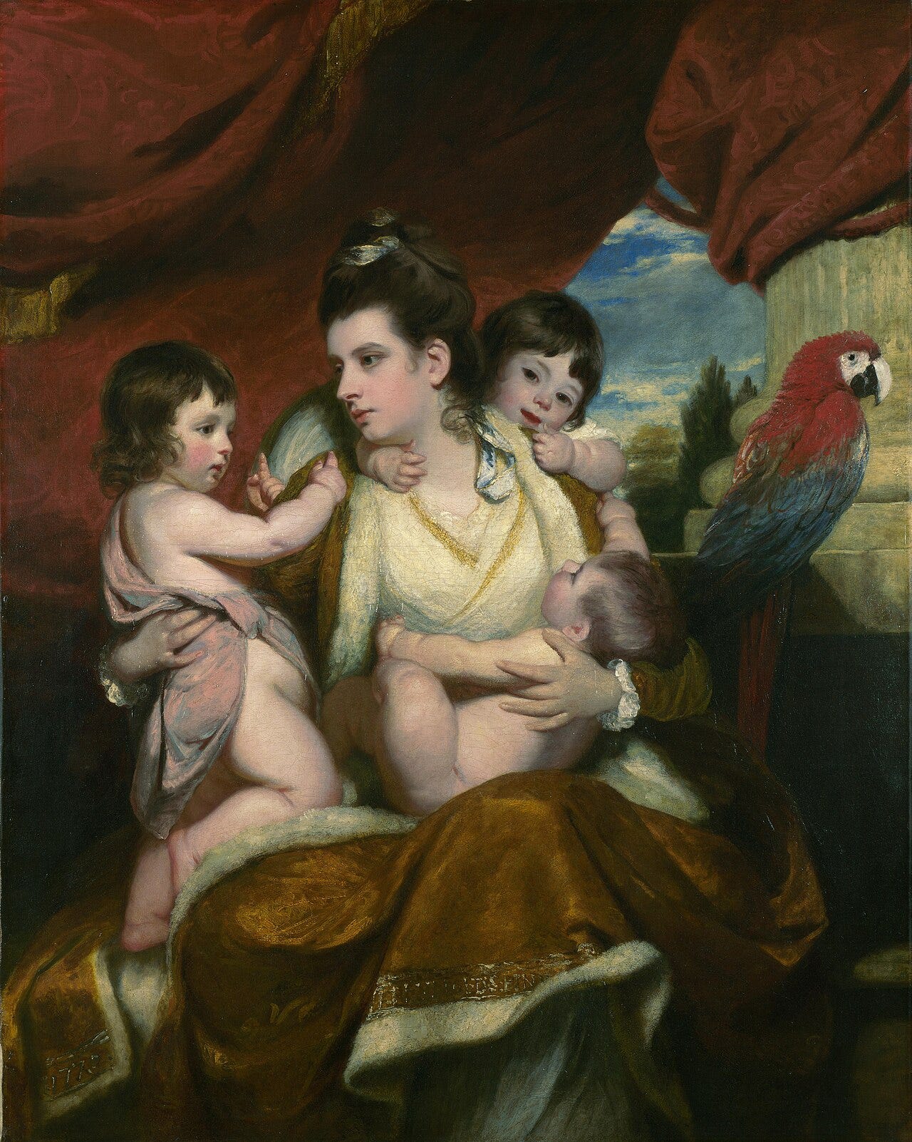 A mother with three young sons climbing over her, a macaw above A mother with three young sons climbing over her, a macaw above