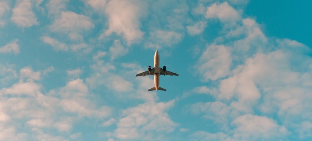 white airplane flying in the sky during daytime white airplane flying in the sky during daytime
