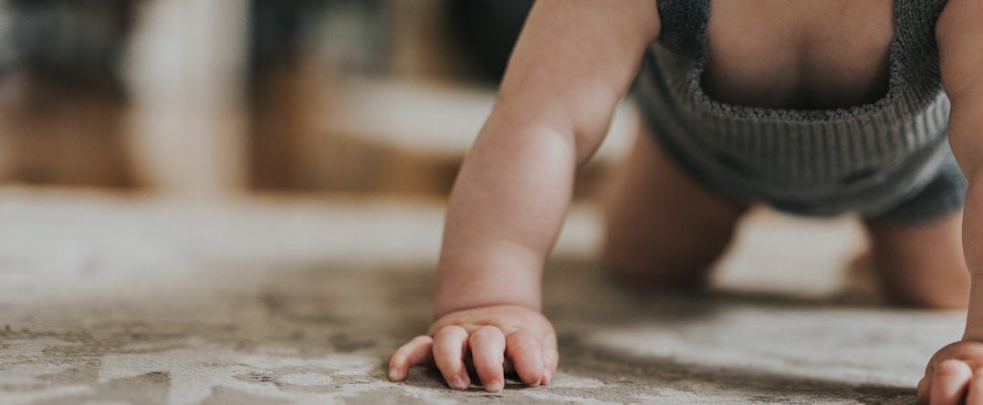 baby wearing grey shirt
