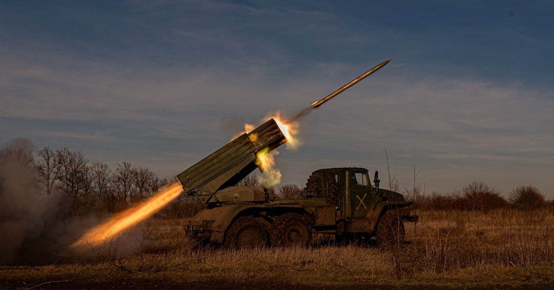 a military vehicle with a missile in the air