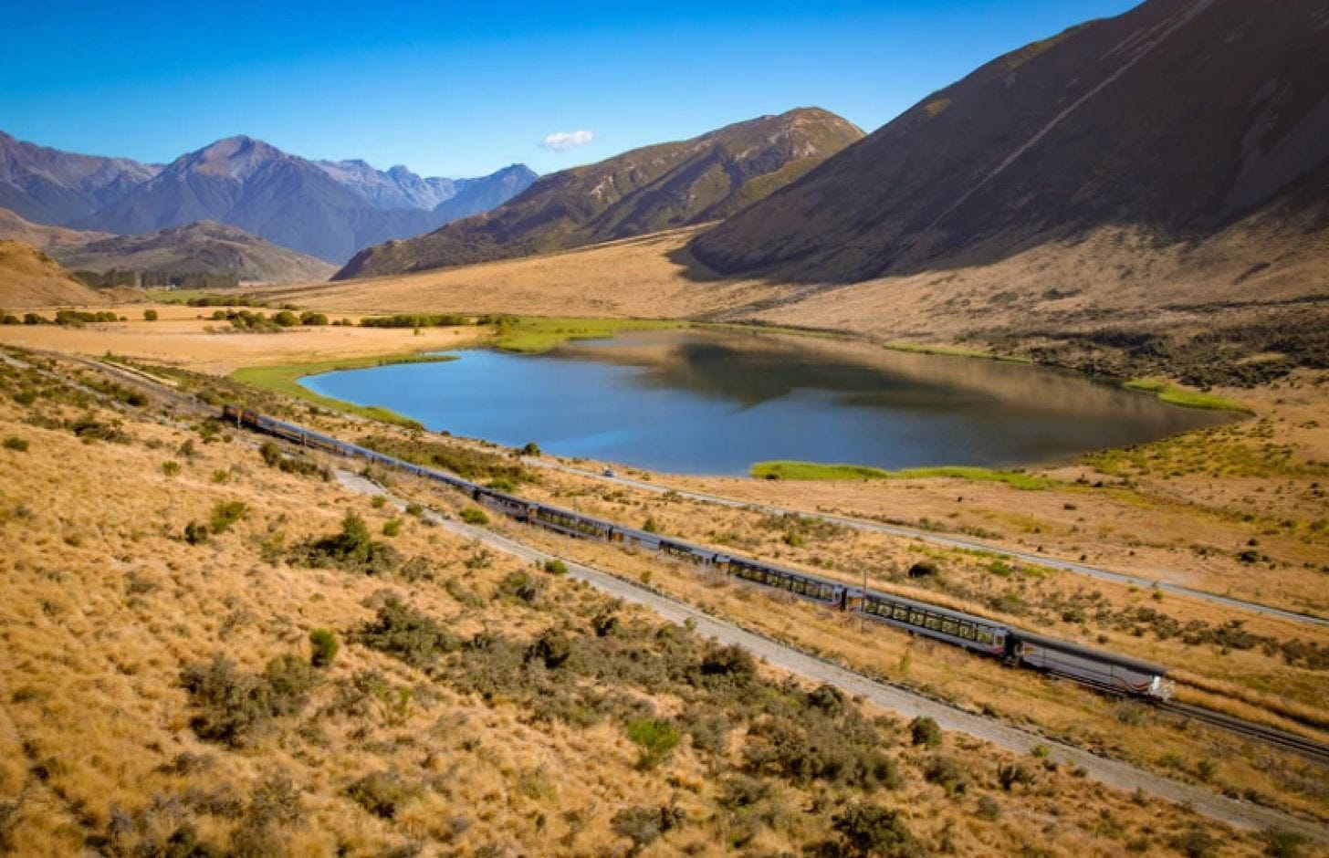 The TranzAlpine train traveling through the Southern Alps of New Zealand. The TranzAlpine train traveling through the Southern Alps of New Zealand.