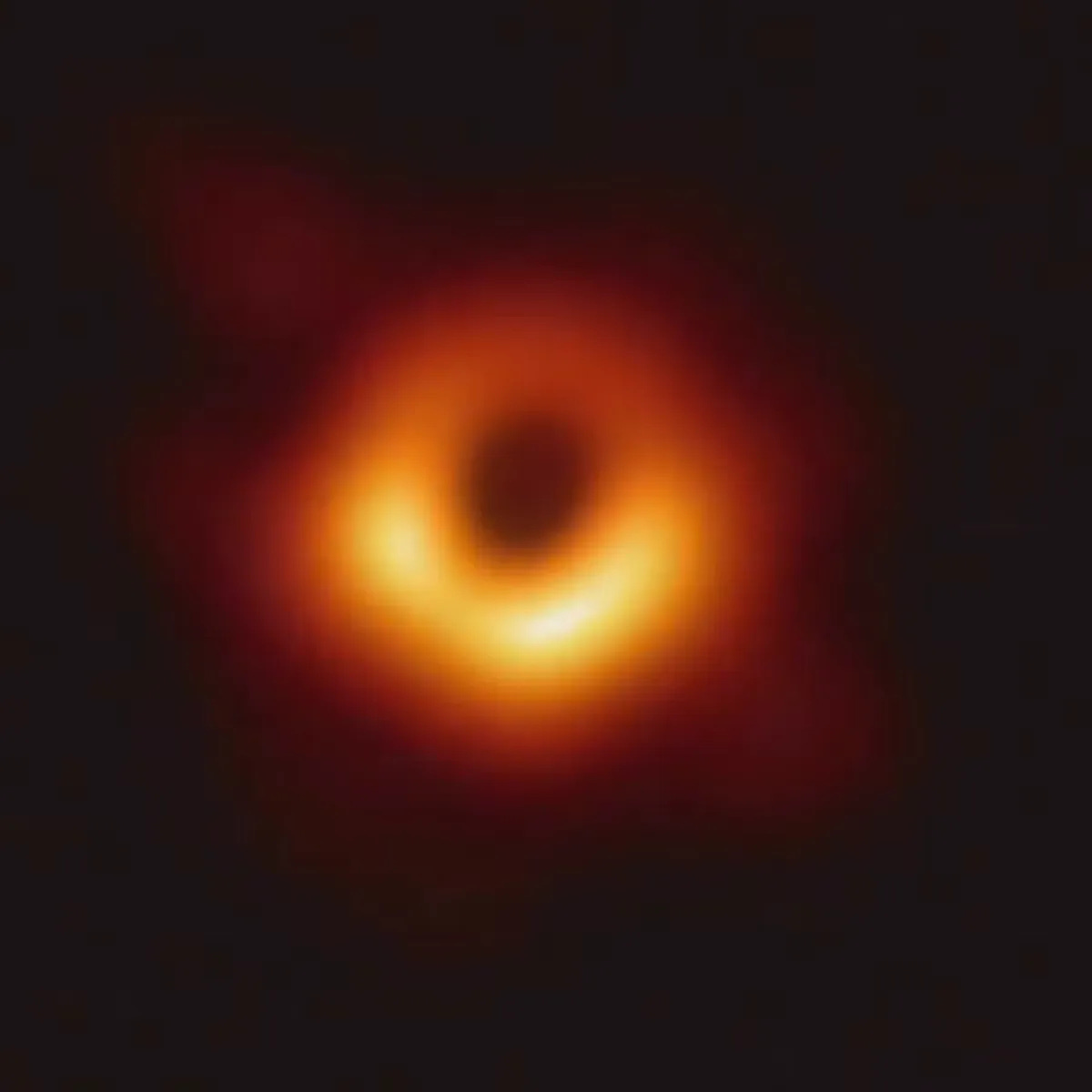 A dark center ringed by glowing orange light A dark center ringed by glowing orange light