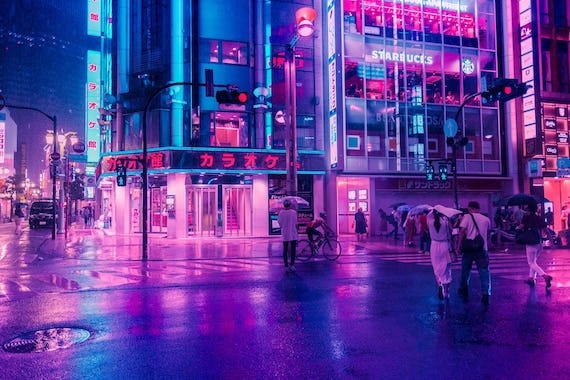 A street in Tokyo, Japan, featuring multiple neon lights in cyan and magenta colors.