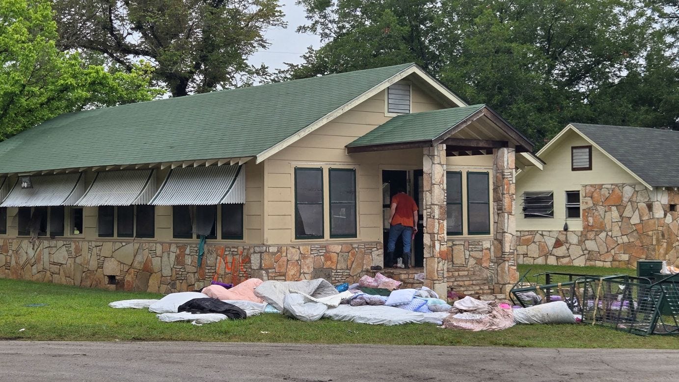 Michael McCown, father of 8-year-old Linnie McCown, searches Camp Mystic's Bubble Inn on July 5 after floodwaters subsided. He later learned his daughter died in the flood.