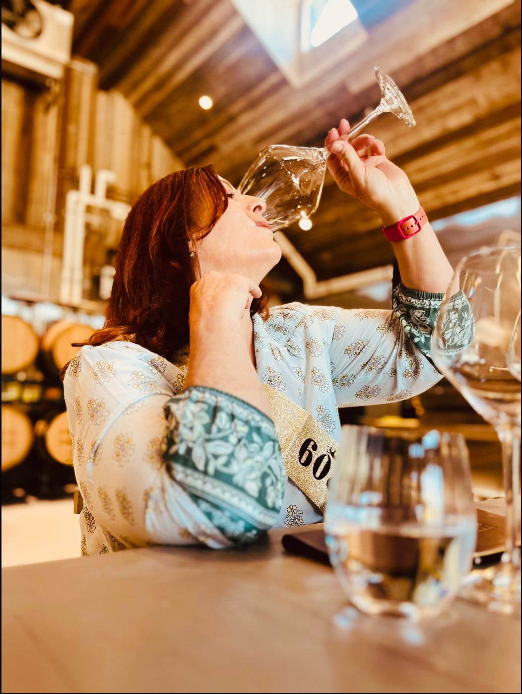 Jen Blair tasting wine in a barrel room — WSET Diploma candidate and creator of The Vine at The Dinner Bell