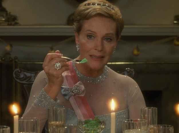 This may contain: a woman is sitting at a table with candles in front of her and holding a toothbrush up to her mouth This may contain: a woman is sitting at a table with candles in front of her and holding a toothbrush up to her mouth