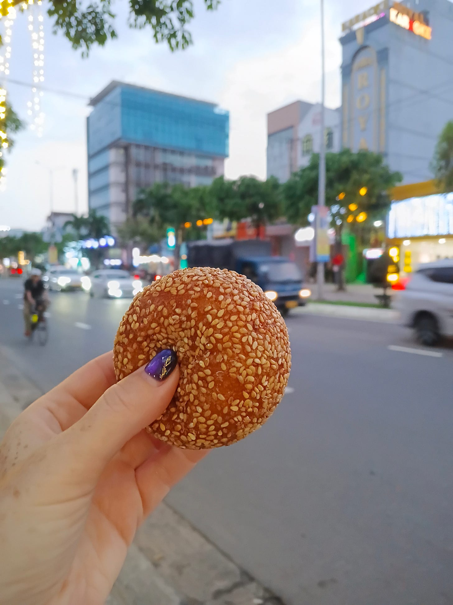 a sesame ball held up on a walk