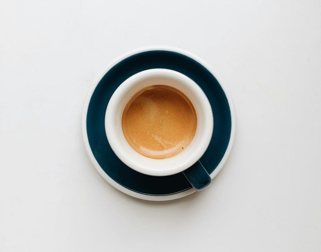cup of coffee on top of saucer cup of coffee on top of saucer