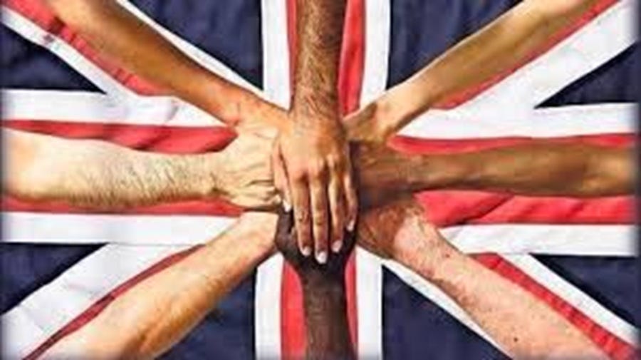 Five hands of different ethnicities overlapping at the centre of a Union Jack flag, symbolising multicultural Britain and the shared identity of communities including Windrush, Irish, Muslim, Jewish and migrant populations.