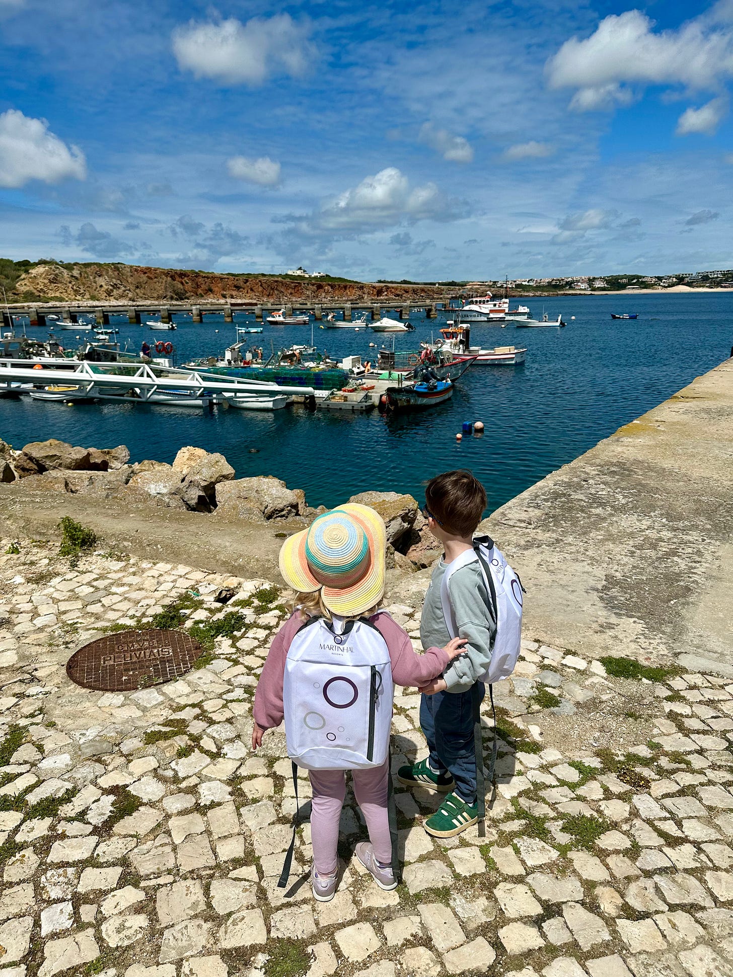 two children watching the boats at Sagres Harbor two children watching the boats at Sagres Harbor