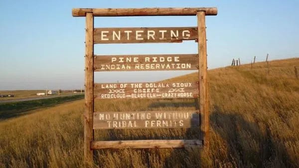 A sign in a field

AI-generated content may be incorrect.