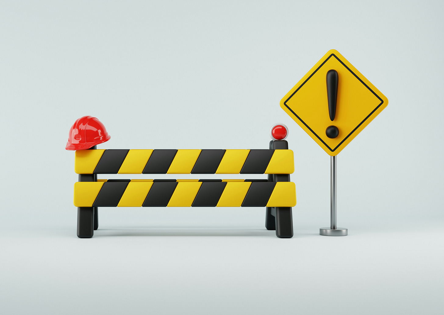 A black and yellow stripped barrier next to a yellow sign with a black exclamation point. 