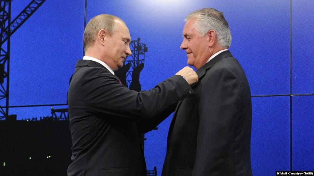 Then-ExxonMobil chief Rex Tillerson receives a state friendship award from Russian President Vladimir Putin in St. Petersburg in 2013.
