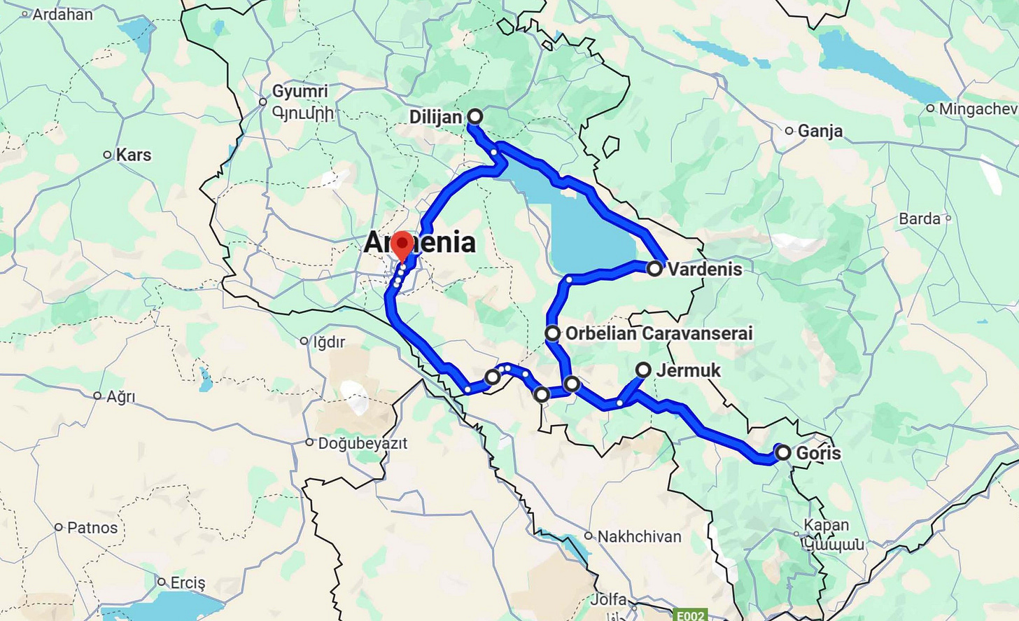 A map of a road trip itinerary is outlined in bright blue across a green map of Armenia.  