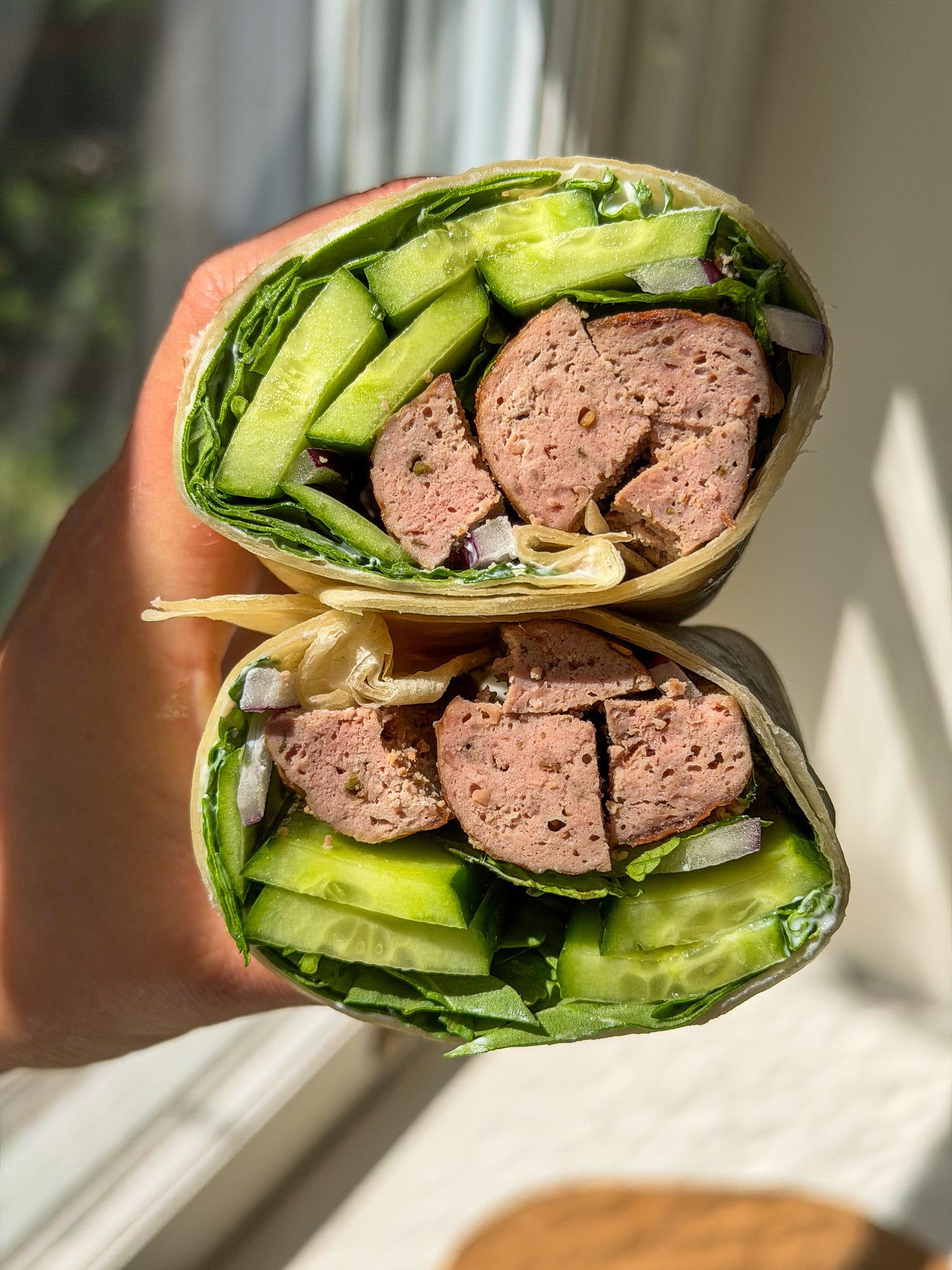 Za’atar lamb sandwich wrap sliced in half with garlicky yogurt and fresh herbs Za’atar lamb sandwich wrap sliced in half with garlicky yogurt and fresh herbs