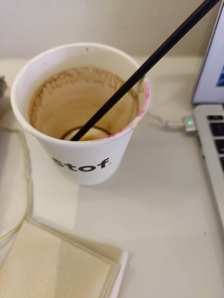 enjoying a hot Americano + empty cup