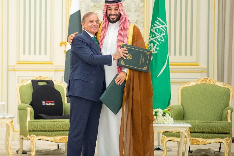 Saudi Crown Prince Mohammed bin Salman and Pakistan Prime Minister Shehbaz Sharif embrace each other on the day they sign a defence agreement