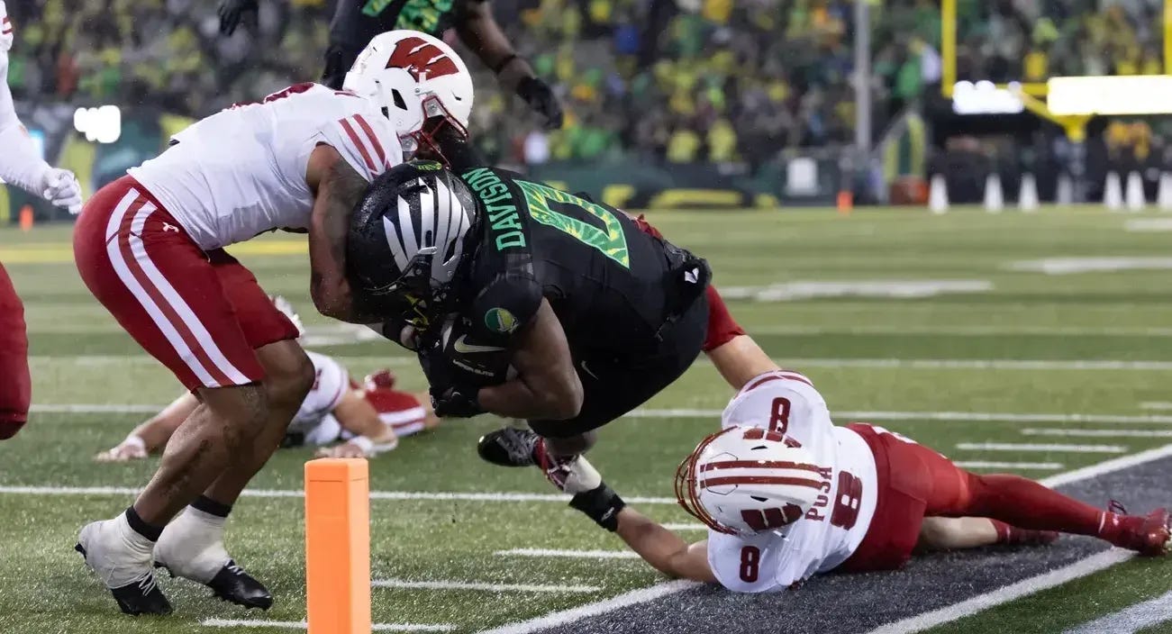 Jordon Davison (0) of the Oregon Ducks dives for the end zone against the Wisconsin Badgers at Autzen Stadium Jordon Davison (0) of the Oregon Ducks dives for the end zone against the Wisconsin Badgers at Autzen Stadium