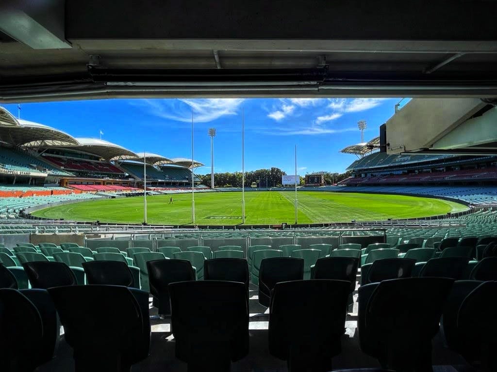 The Adelaide Oval stadium against a blue sky