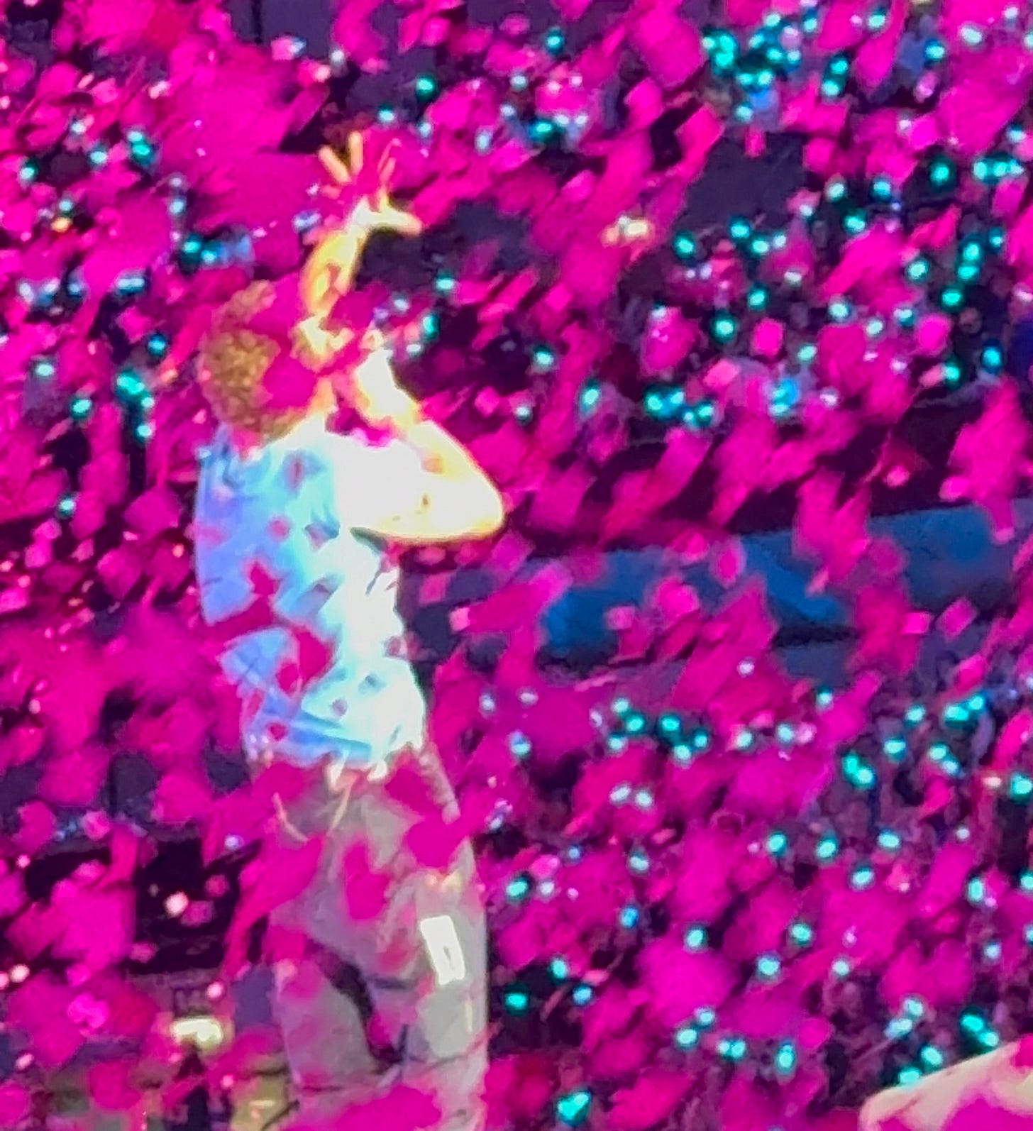 chris martin of coldplay singing in among pink confetti
