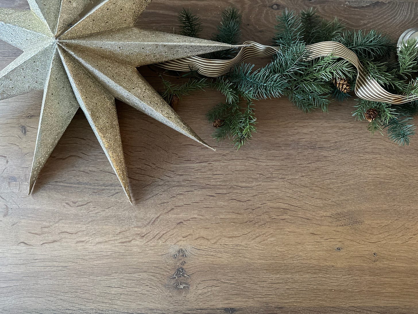 A gold star with greenery