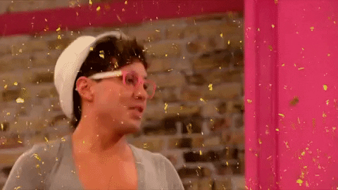 A man throws glitter into the air. 